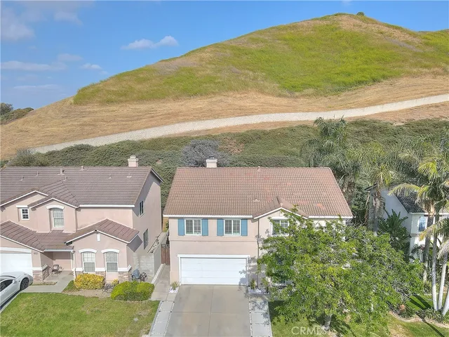 an aerial view of residential houses with outdoor space and ocean view