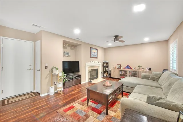 a living room with fireplace furniture and a flat screen tv