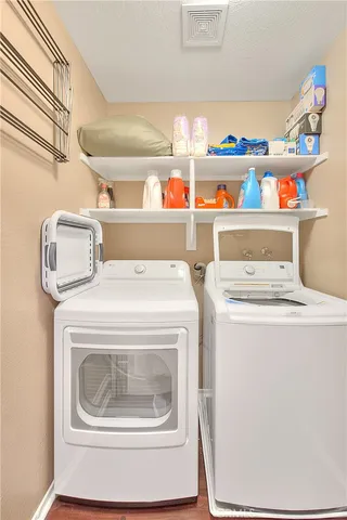 a view of a backyard with couches plants and large tree