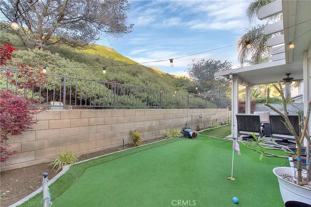 a view of a patio with table and chairs potted plants and palm tree