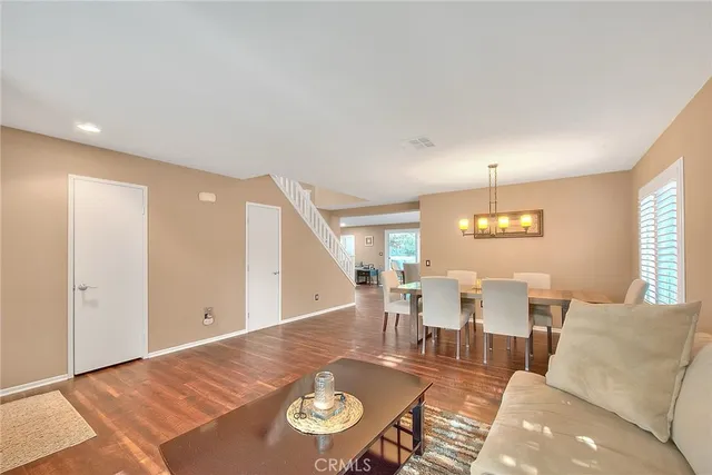a living room with lots of furniture and view of dining room