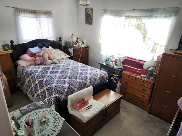 a bed room with a bed and a window