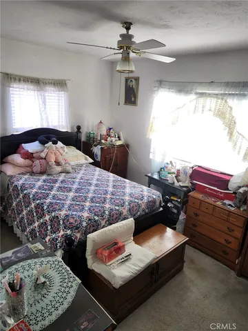 a bedroom with furniture and a chandelier