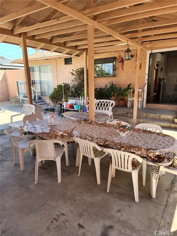 a view of a porch with furniture and a yard