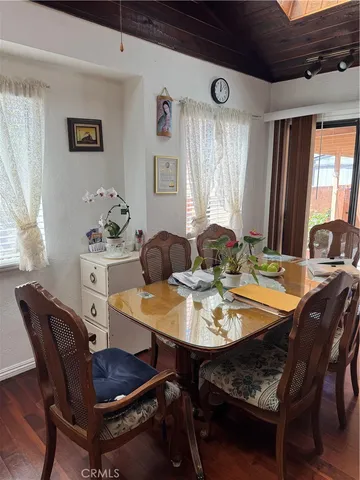 a view of a dining room with furniture and window
