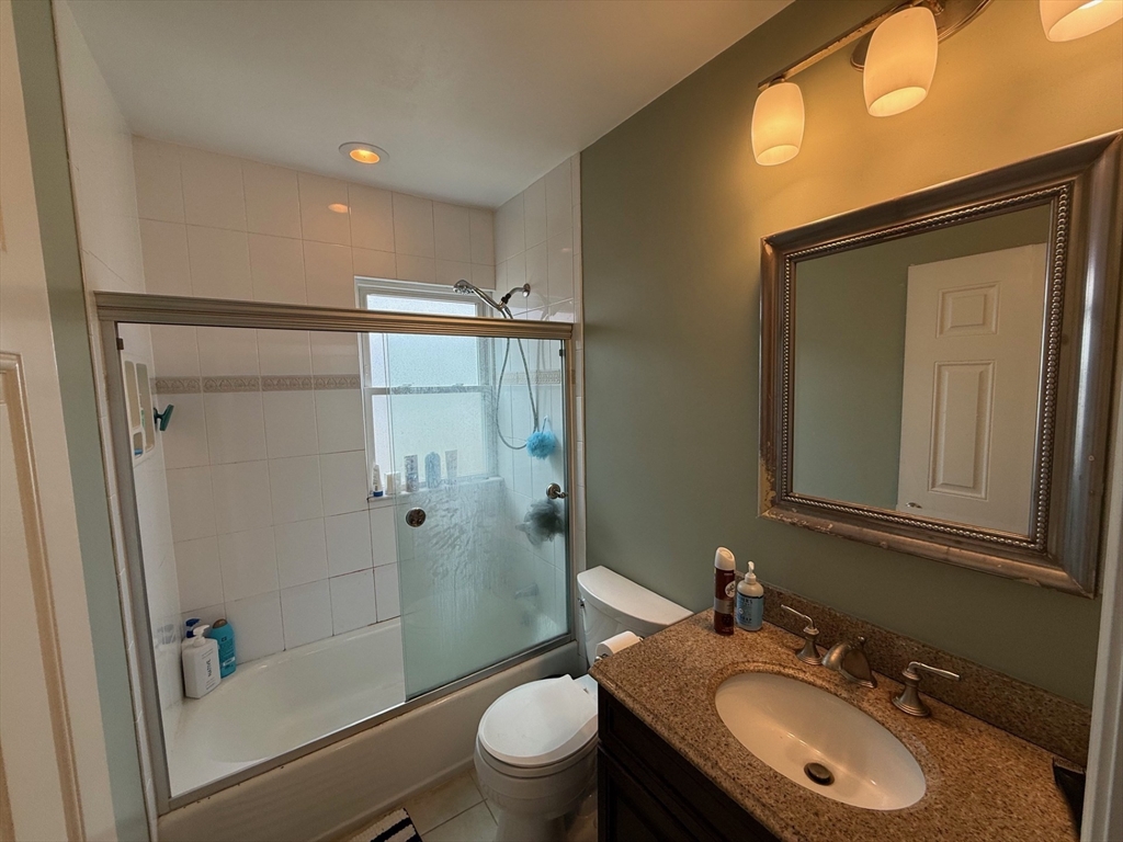 72 Bennett Street, Unit 72 Boston, MA 02135 - Photo 9 of 17 a bathroom with a sink a toilet and shower
