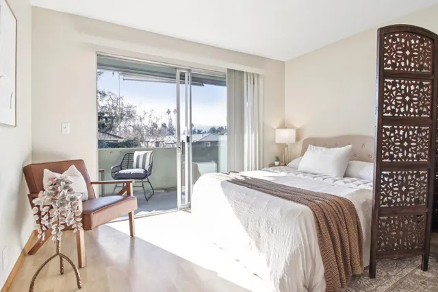 a spacious bedroom with a bed and a table in it