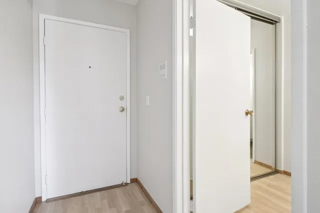 a view of a hallway with wooden floor