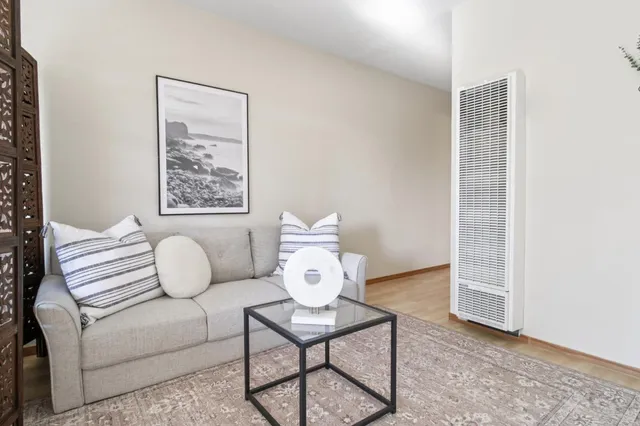 a living room with furniture and white walls