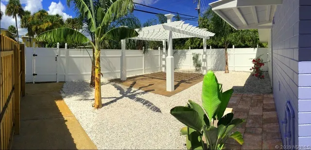 a view of a house with a small yard