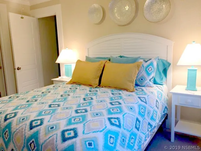 a bedroom with a bed and lamp