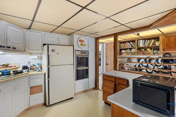 a kitchen with stainless steel appliances granite countertop a refrigerator and a stove