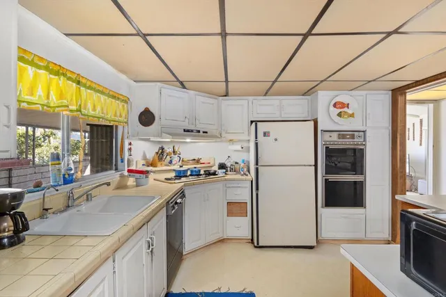 a kitchen with a refrigerator a sink and a stove