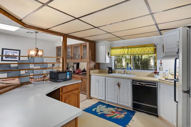 a kitchen that has a sink and a stove