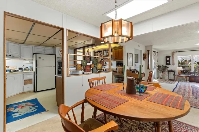 a dining room with furniture and a chandelier
