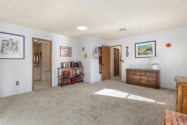 a living room with furniture and a walk in closet