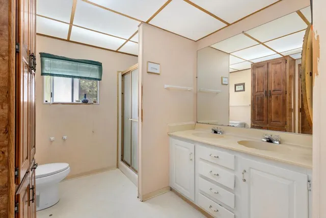 a bathroom with a granite countertop sink toilet and shower