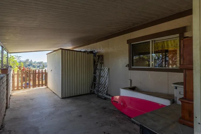 a view of a room with furniture and a window
