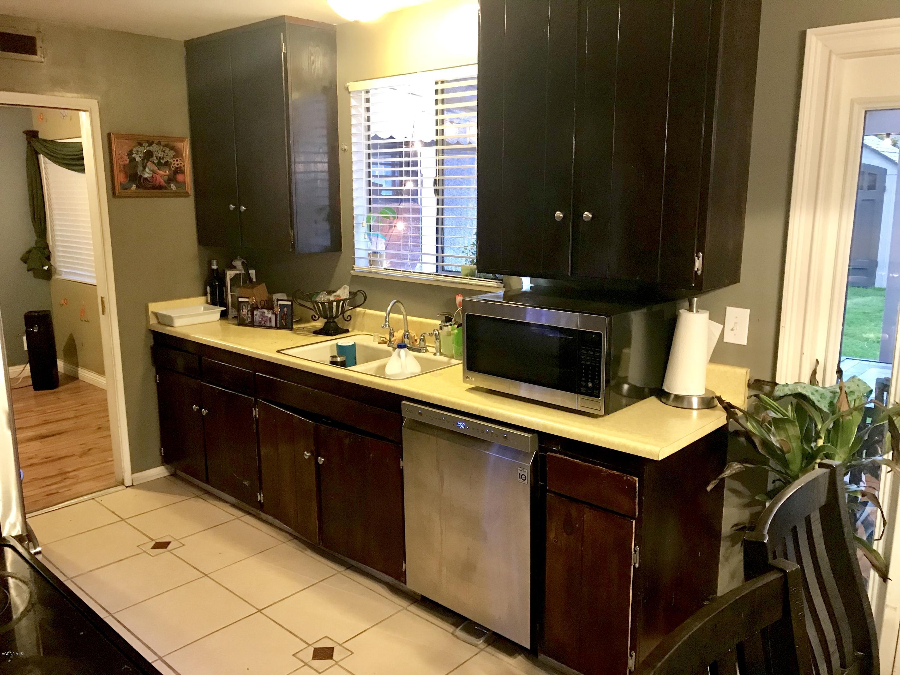 4010 South J Street Oxnard, CA 93033 - Photo 18 of 18 a kitchen with a sink cabinets and a table