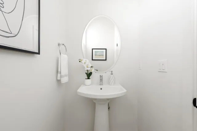 a bathroom with a sink a mirror and a window
