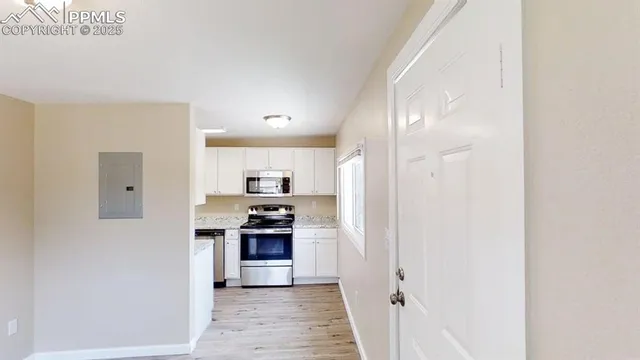 a kitchen with stainless steel appliances granite countertop a stove and a refrigerator