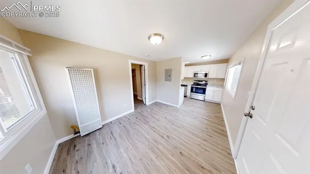 a view of a kitchen from a hallway