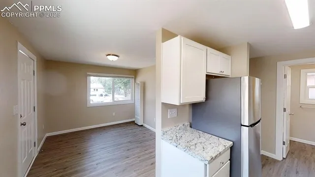 a kitchen with stainless steel appliances granite countertop a refrigerator and a stove