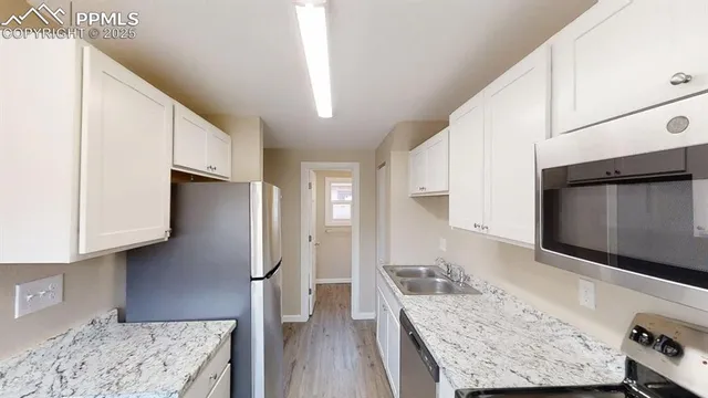 a kitchen with stainless steel appliances granite countertop a refrigerator stove and oven