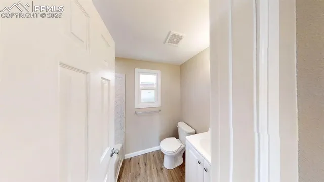 a bathroom with a toilet sink and a mirror