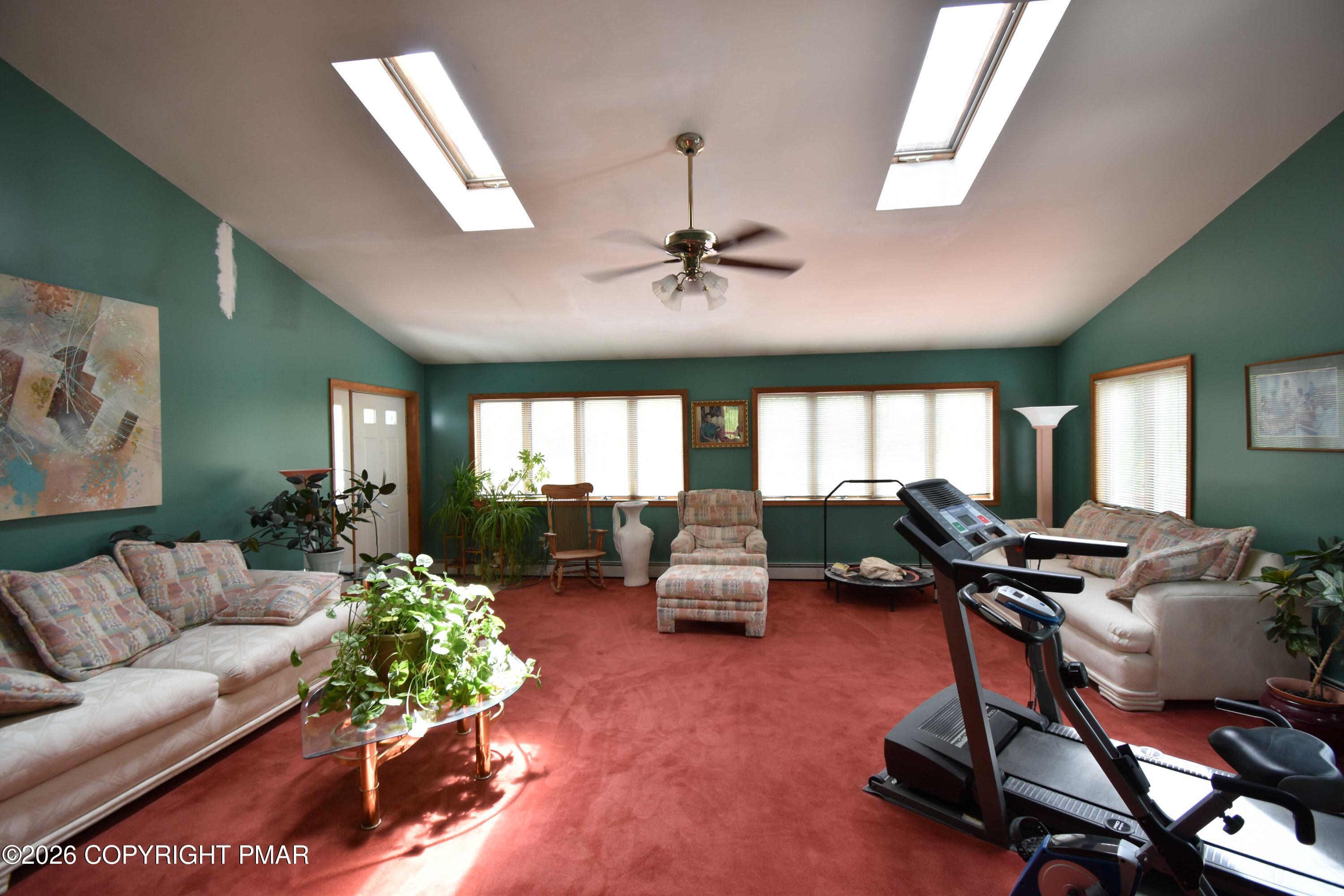160 Quiet Valley Road Mount Bethel, PA 18343 - Photo 13 of 44 a living room with furniture gym equipment and a large window