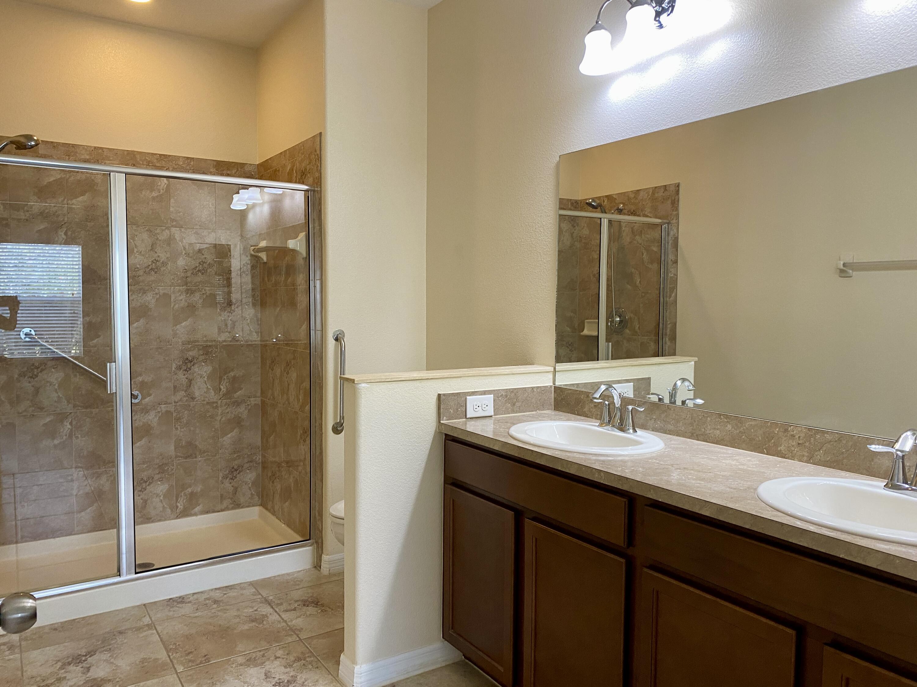 3490 Funston Circle Melbourne, FL 32940 - Photo 14 of 25 a bathroom with a shower sink and mirror