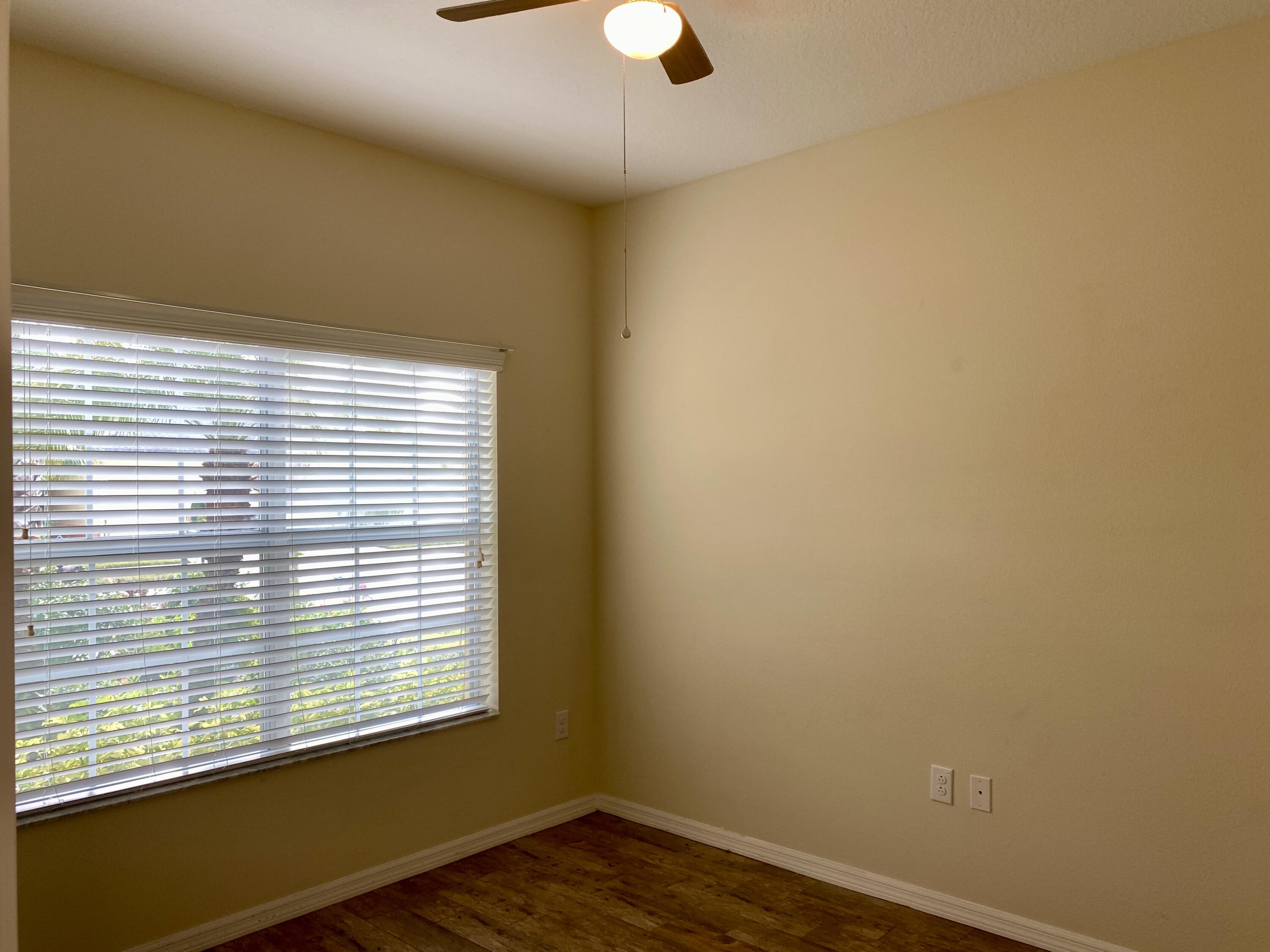 3490 Funston Circle Melbourne, FL 32940 - Photo 16 of 25 a view of an empty room with wooden floor and a window