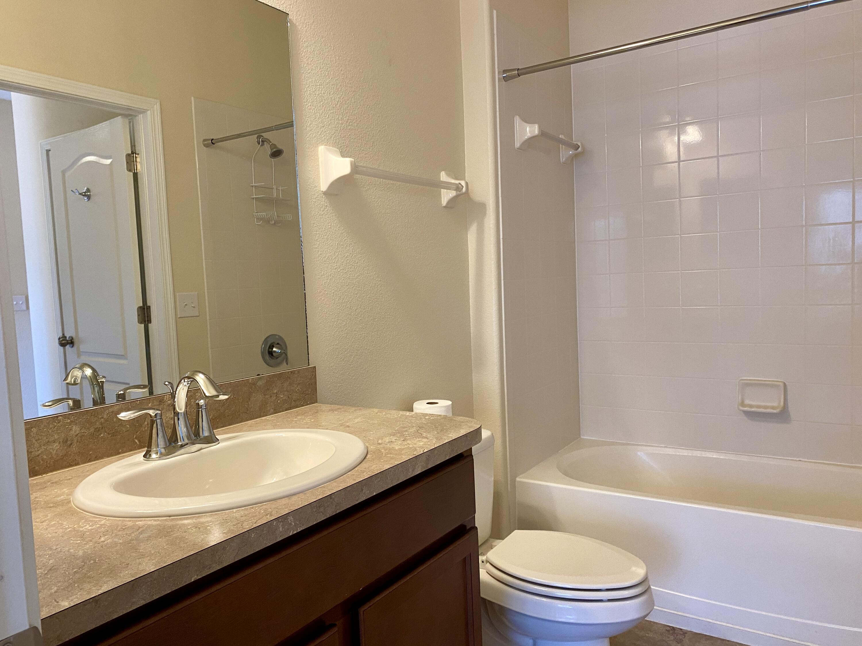3490 Funston Circle Melbourne, FL 32940 - Photo 19 of 25 a bathroom with a granite countertop sink toilet and shower