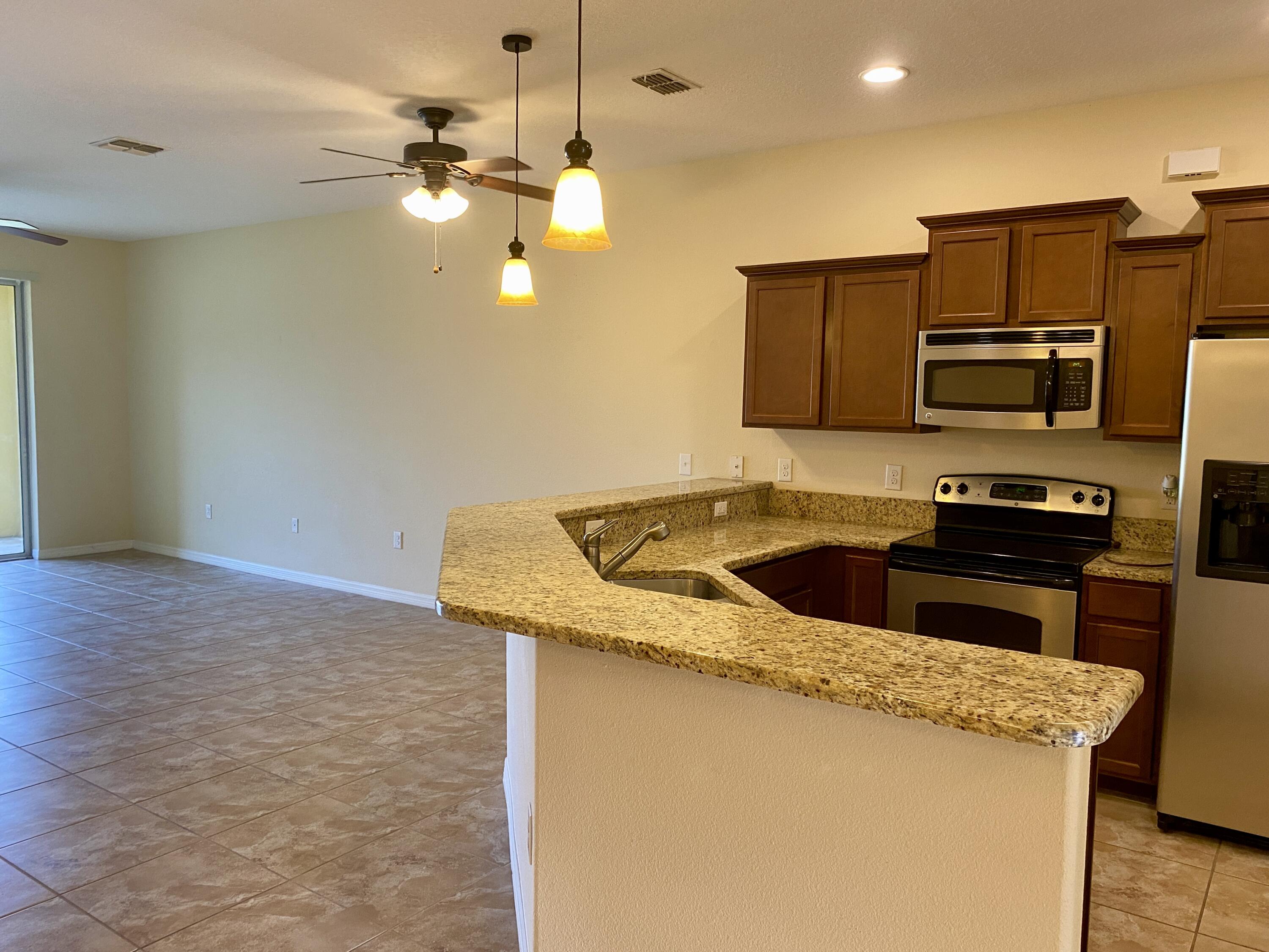 3490 Funston Circle Melbourne, FL 32940 - Photo 6 of 25 a kitchen that has a sink and a stove top oven