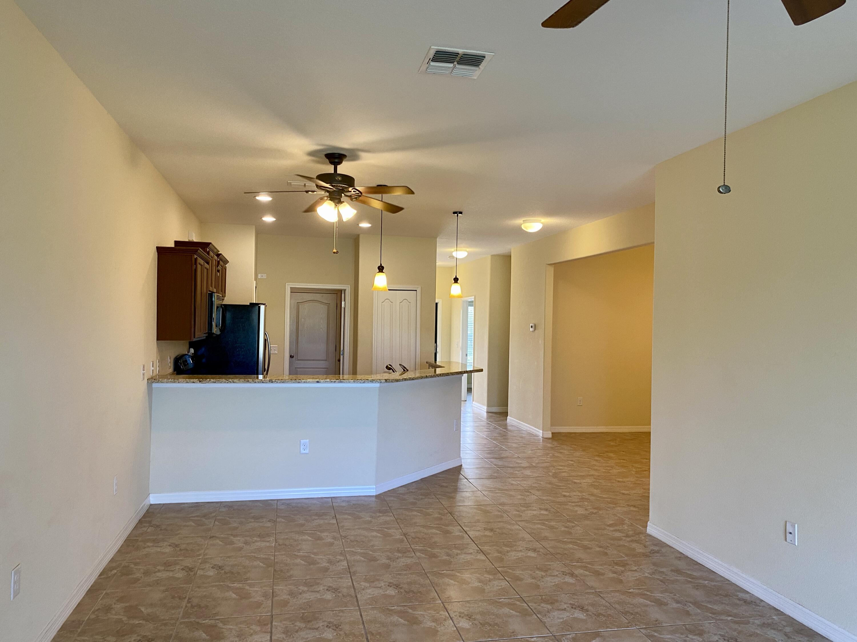 3490 Funston Circle Melbourne, FL 32940 - Photo 10 of 25 a view of a kitchen with a sink and a refrigerator