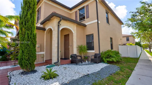 a front view of a house with garden