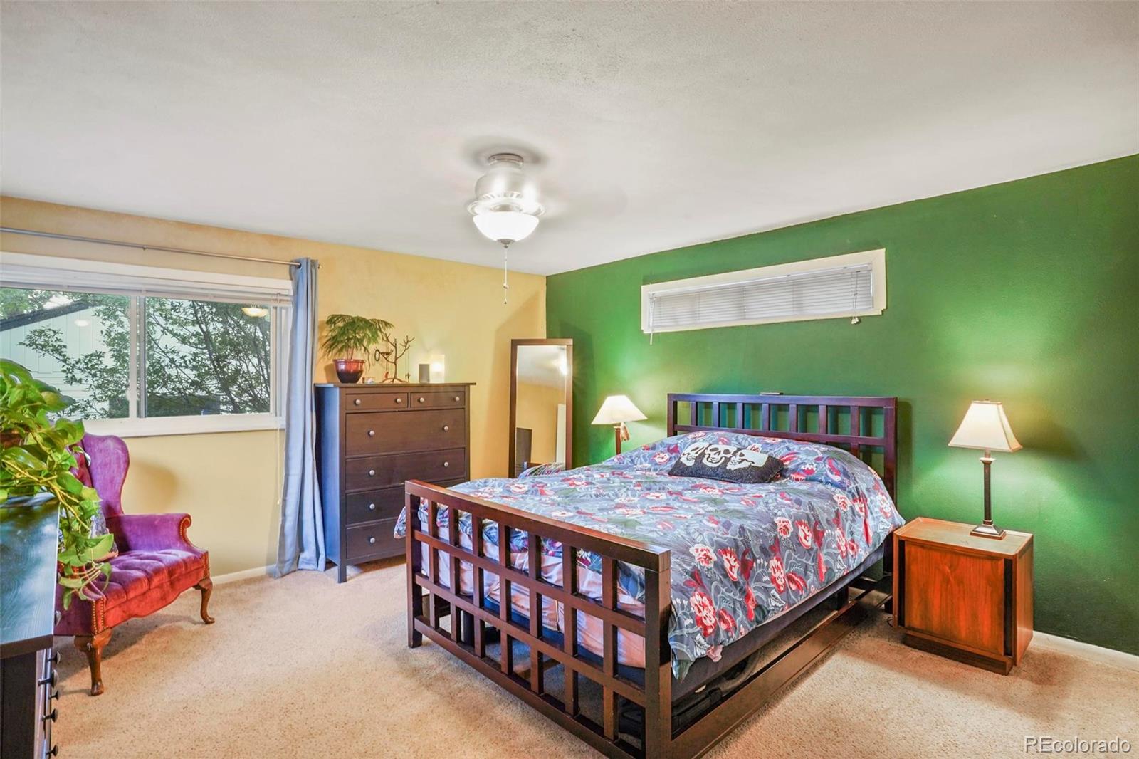 2805 Fenton Street Wheat Ridge, CO 80214 - Photo 18 of 40 a bedroom with a bed and a chandelier