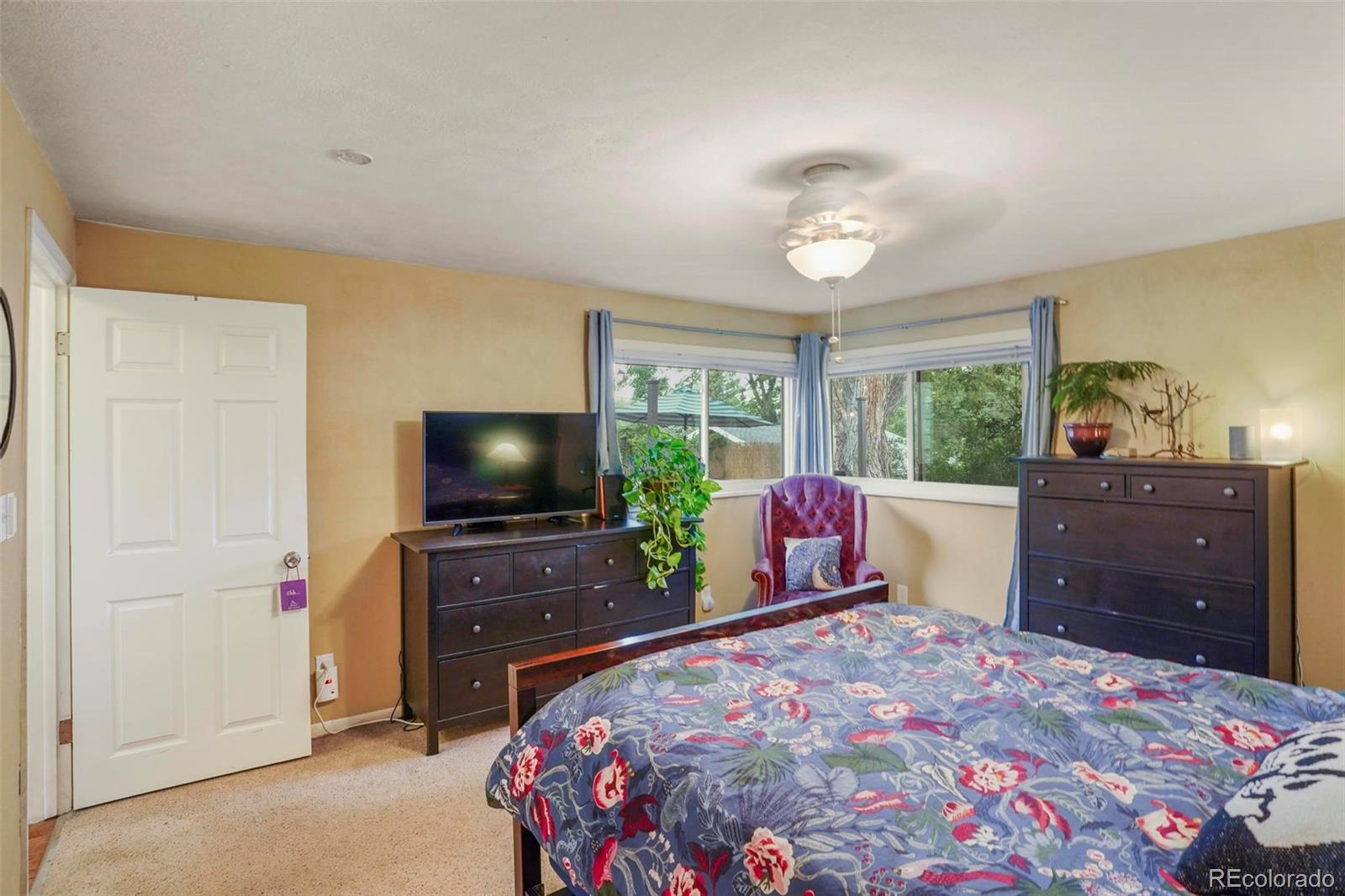 2805 Fenton Street Wheat Ridge, CO 80214 - Photo 19 of 40 a bedroom with a bed and a flat screen tv