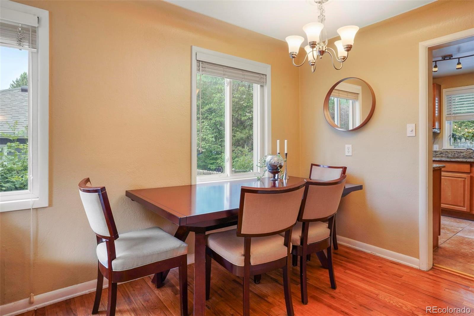 2805 Fenton Street Wheat Ridge, CO 80214 - Photo 7 of 40 a dining room with chandelier and a window
