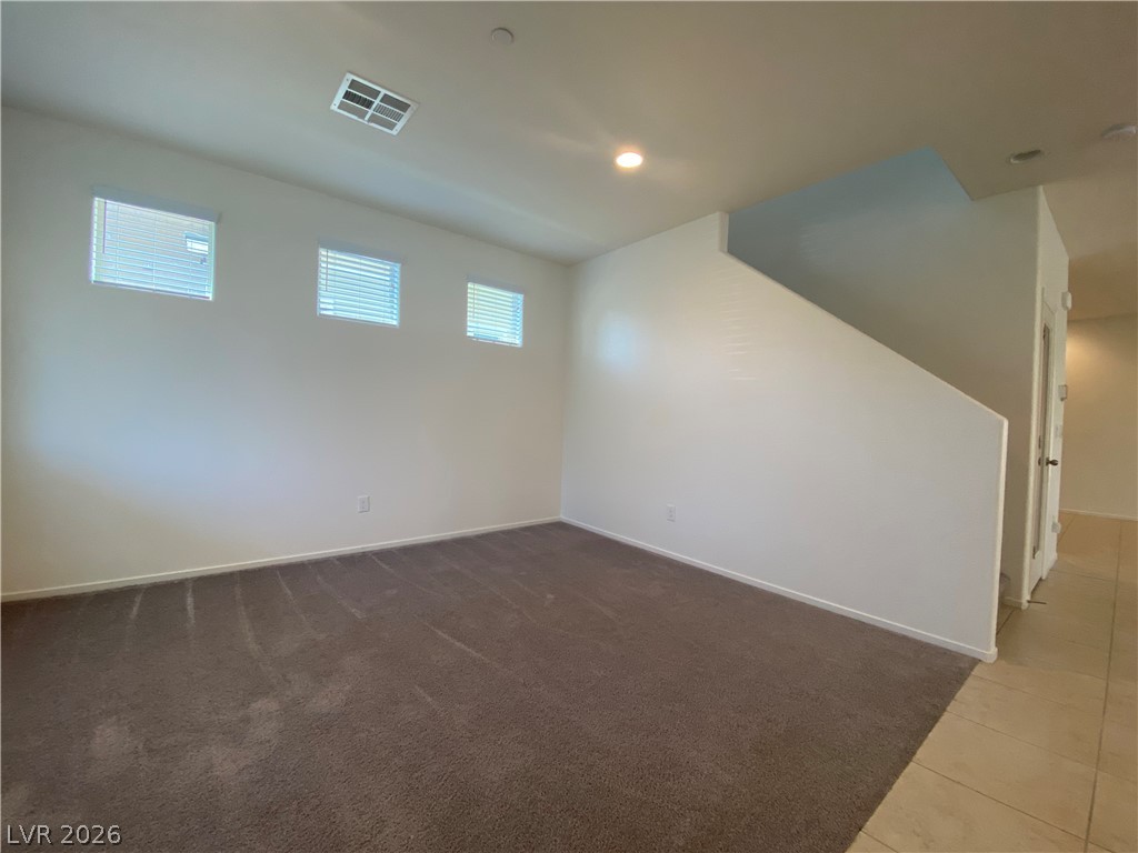 436 Cadence View Way Henderson, NV 89011 - Photo 10 of 36 A spacious room offers comfortable carpet flooring and naturally illuminated interiors.