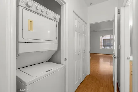 a view of a storage and utility room with wooden floor