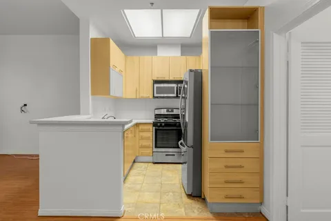 a kitchen with a refrigerator and a stove