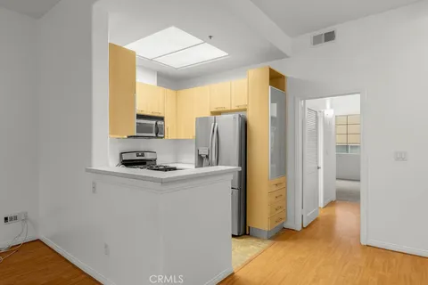 a kitchen with stainless steel appliances a refrigerator and a stove