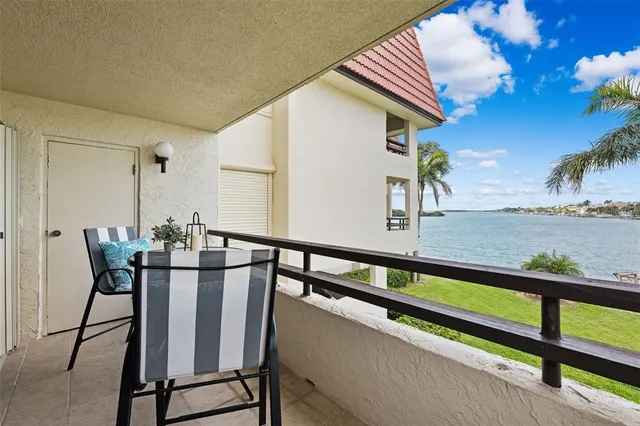 a kitchen with granite countertop white cabinets white appliances and a sink