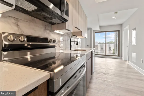 a kitchen with a stove and a sink
