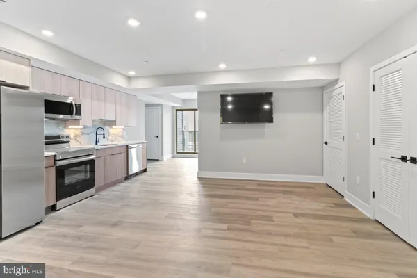 a kitchen with stainless steel appliances a refrigerator and a stove top oven
