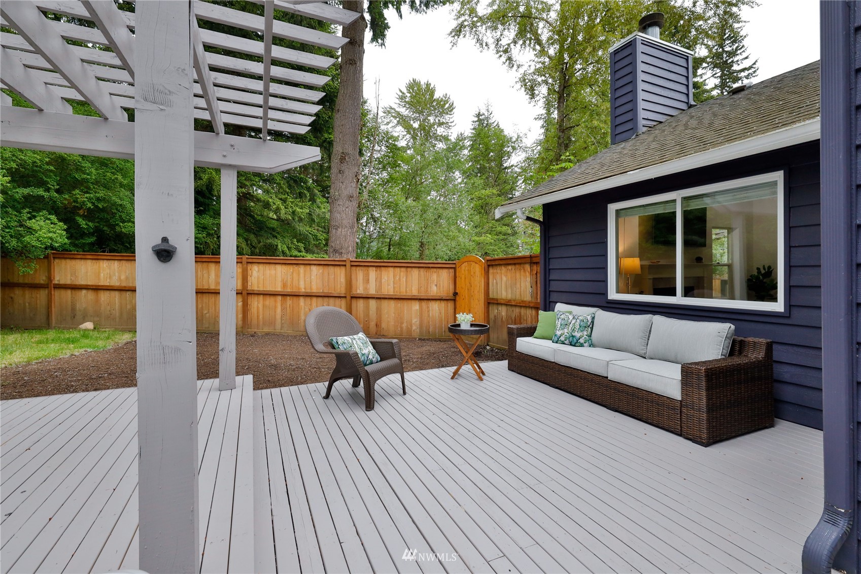 415 170th Place Southwest Bothell, WA 98012 - Photo 31 of 36 a view of a patio with couches and table with wooden floor and fence