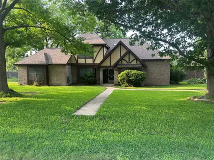 a front view of a house with yard and green space