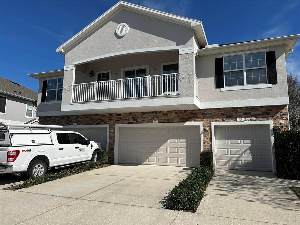 a front view of a house with parking space
