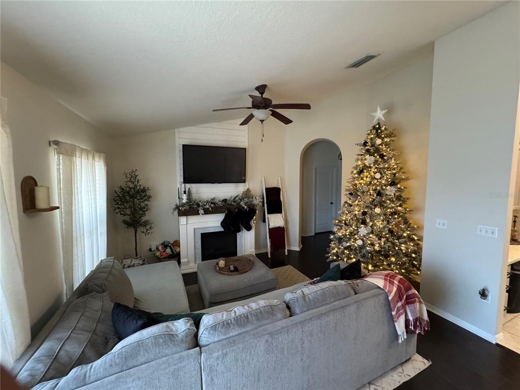 2318 Tanbark Ridge Place, Unit 2318 Plant City, FL 33563 - Photo 15 of 64 a living room with furniture flowers and a chandelier